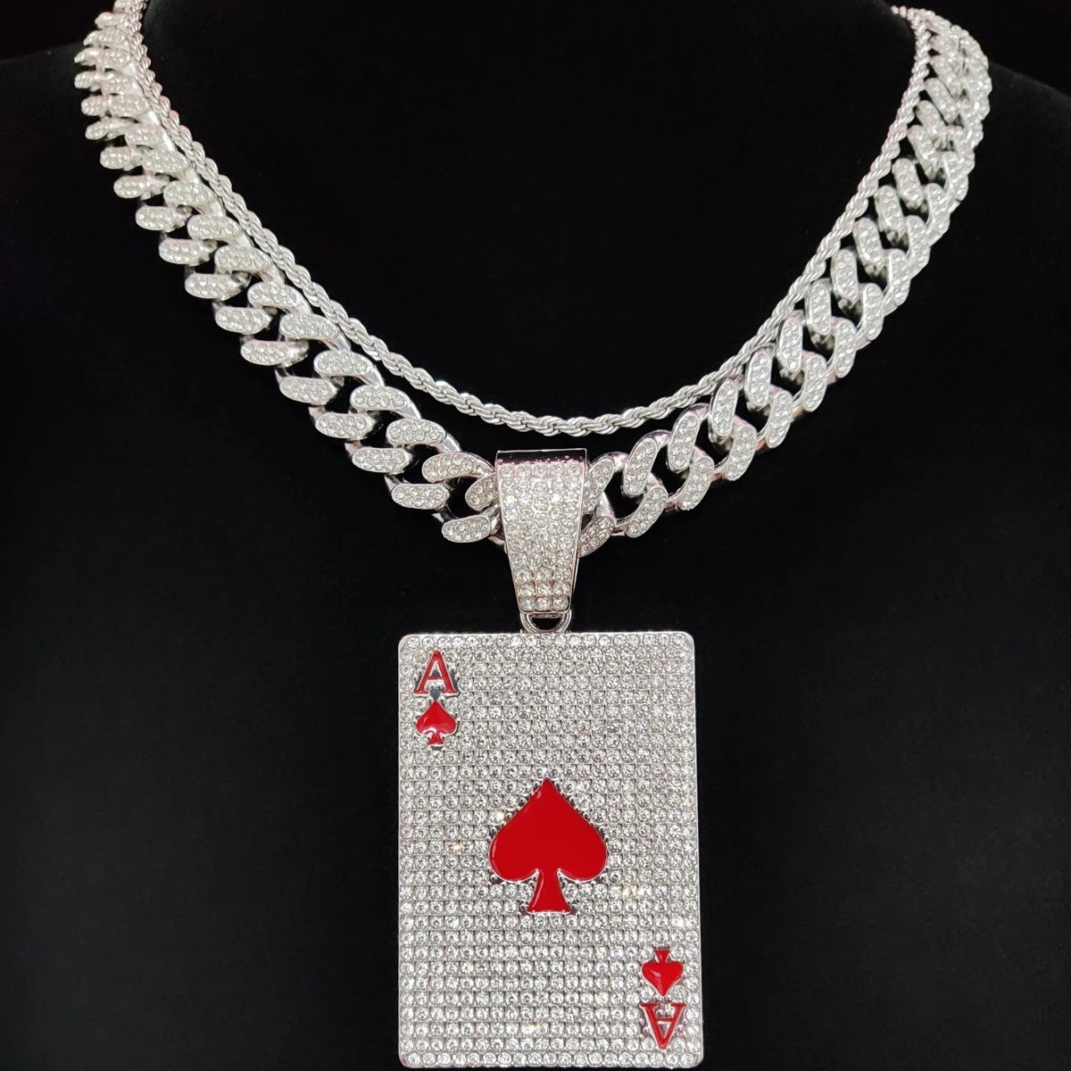 Necklace with a diamond-encrusted ace of spades pendant on a black background